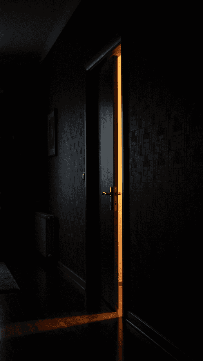 Golden Glow from Ajar Doorway — phone wallpaper