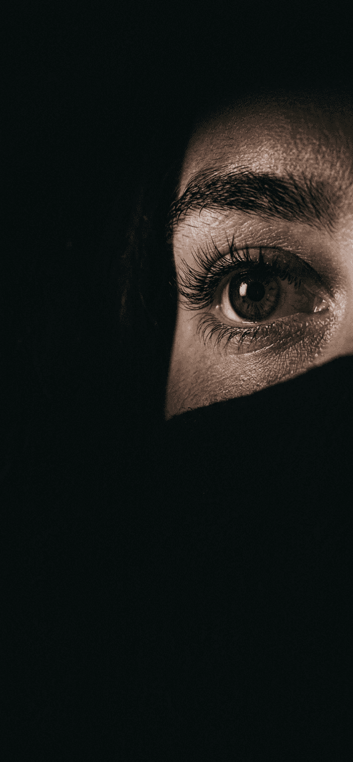 Mysterious Eye Gaze in Deep Shadow — phone wallpaper